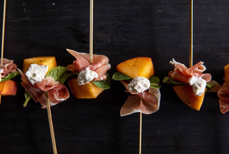 Fresh peach and prosciutto appetizer with mint and house made mozzarella from Bistro Catering in Jackson Hole, Wyoming.