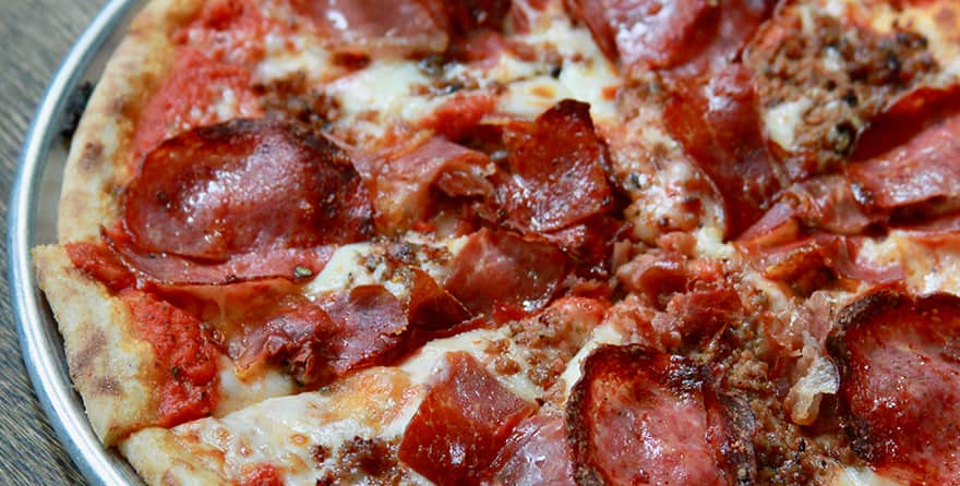 Brick fired pizza with pomodoro, sopressatta, sausage, prosciutto, speck, mozzarella at Osteria in Jackson Hole, Wyoming.