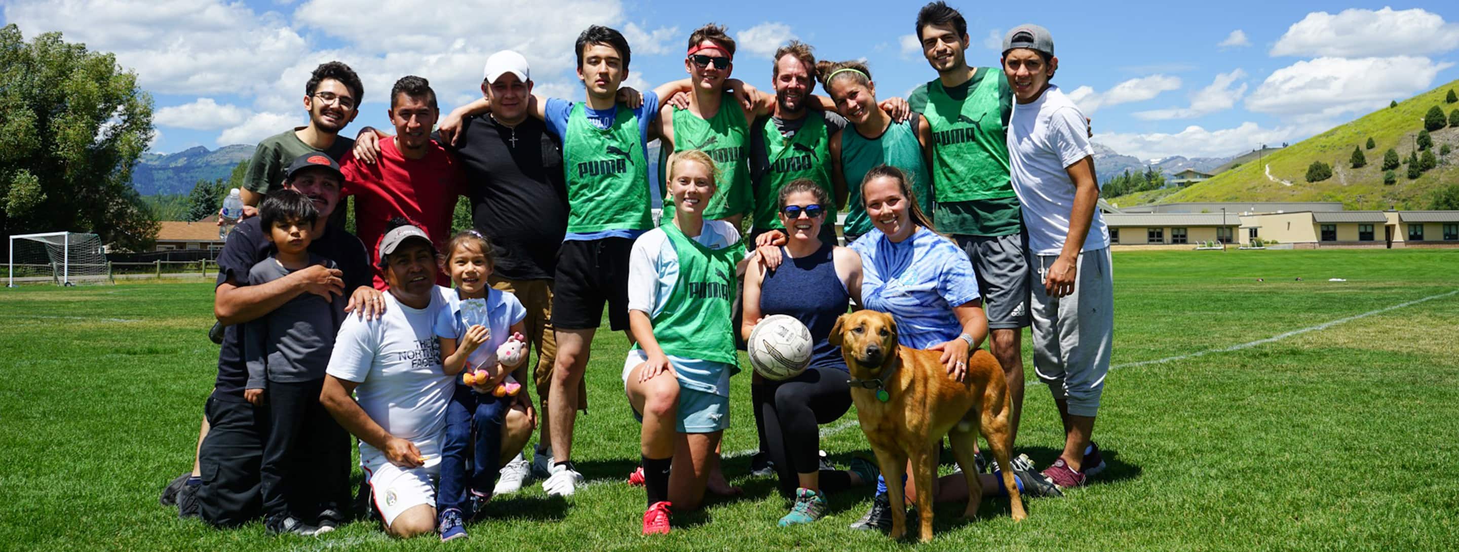 A soccer team sponsored by the Fine Dining Restaurant Group on a field in Jackson Hole, Wyoming.