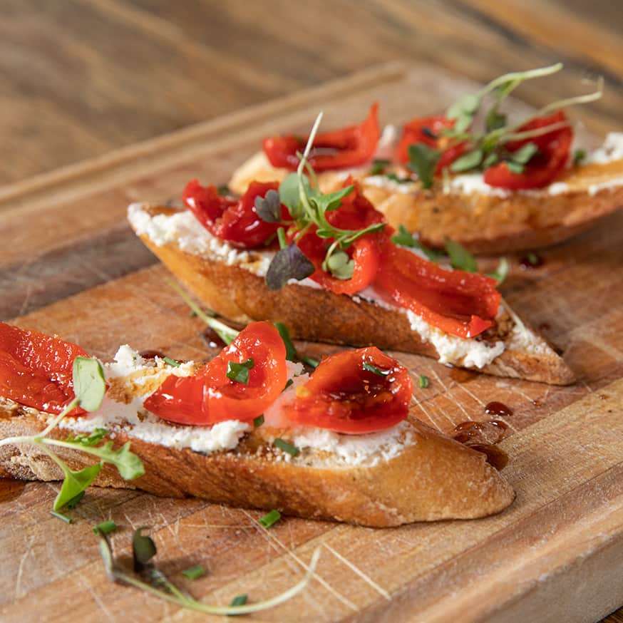 French baguette Crostini with housemaid mozzarella, roasted tomatoes, balsamic glaze, and seasonal sprouts at Bin 22 restaurant in Jackson, Wyoming.