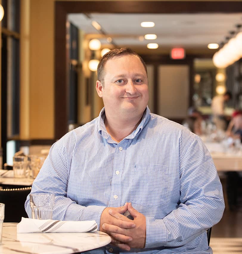 Portrait of Fine Dining Restaurant Group Director of Operations, Kevin Kunce, in the dining room of The Bistro restaurant in Jackson, Wyoming.